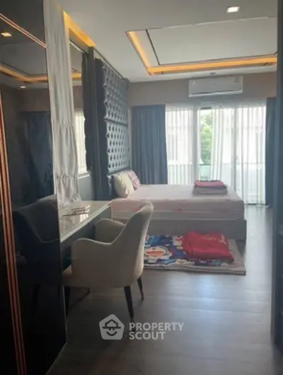 Modern bedroom with stylish decor and large window for natural light