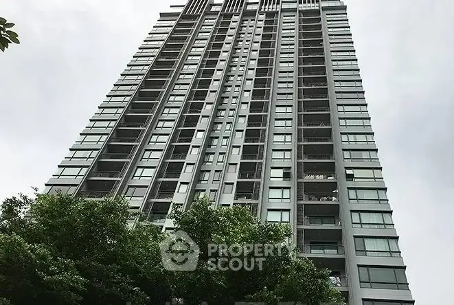 Stunning high-rise building with modern architecture and lush greenery.