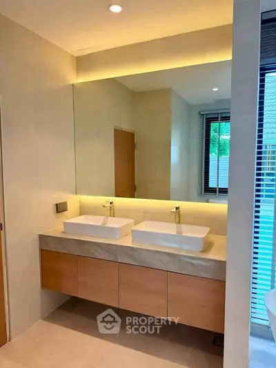Modern bathroom with dual sinks and ambient lighting