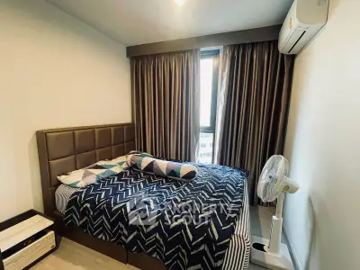 Cozy bedroom with modern decor and air conditioning in a stylish apartment.