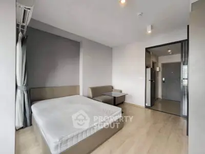 Modern studio apartment with cozy bed and stylish decor