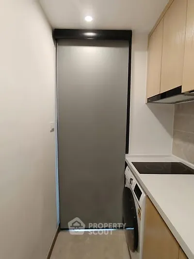 Modern compact kitchen with sleek appliances and minimalist design