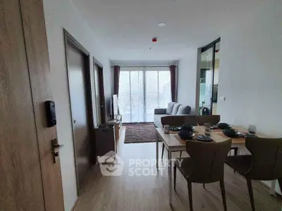 Modern living room with dining area and large windows in stylish apartment