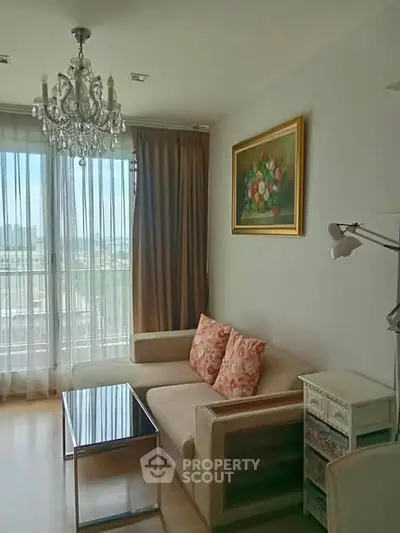 Elegant living room with chandelier and city view, featuring cozy sofa and stylish decor.