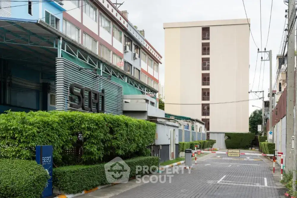 Modern apartment building exterior with lush greenery and secure entrance