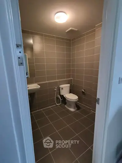 Modern bathroom with sleek gray tiles and contemporary fixtures.