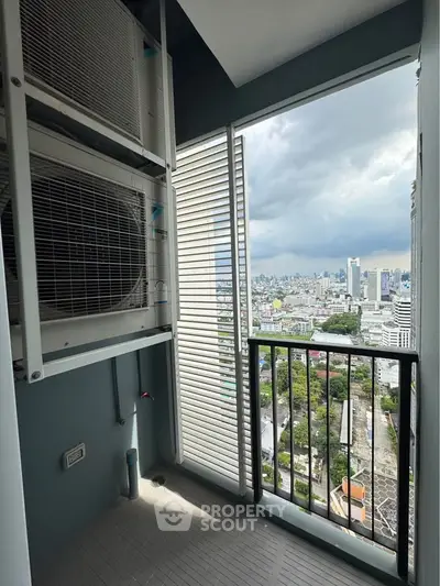 High-rise balcony with city view and air conditioning units