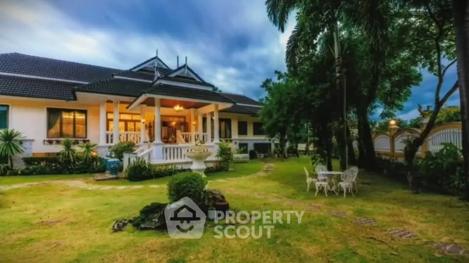 Luxurious villa with lush garden and elegant outdoor seating area