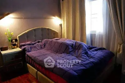 Cozy bedroom with plush bedding and soft lighting, perfect for relaxation.