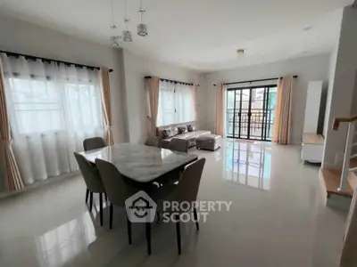 Spacious modern living room with dining area and large windows for natural light.