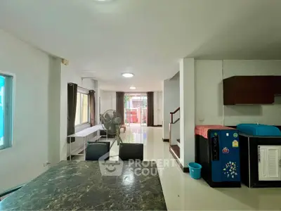 Spacious open-plan living area with modern furnishings and ample natural light, perfect for family gatherings.