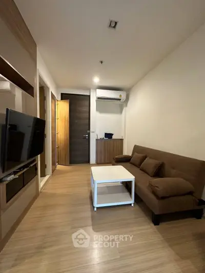 Modern living room with sleek design and cozy brown sofa in a stylish apartment.