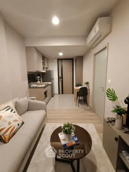 Modern living room with cozy sofa and open kitchen layout