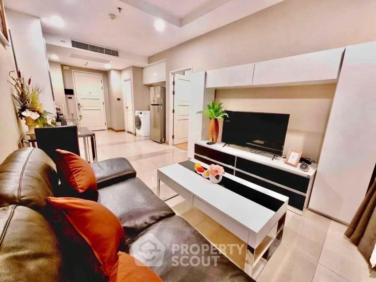 Modern living room with sleek furniture and stylish decor in a cozy apartment setting.