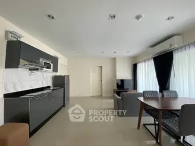 Modern open-plan living room with sleek kitchen and dining area