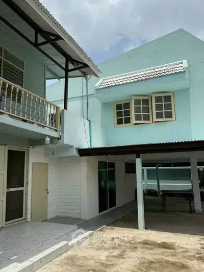 Charming two-story residential building with spacious outdoor area and covered patio.