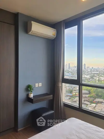 Modern bedroom with large window offering stunning city view and air conditioning unit.