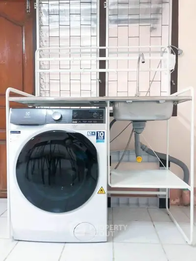 Modern laundry area with washing machine and sink, perfect for efficient home chores.
