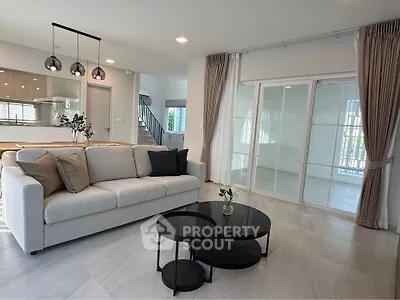 Modern living room with elegant decor and open kitchen layout