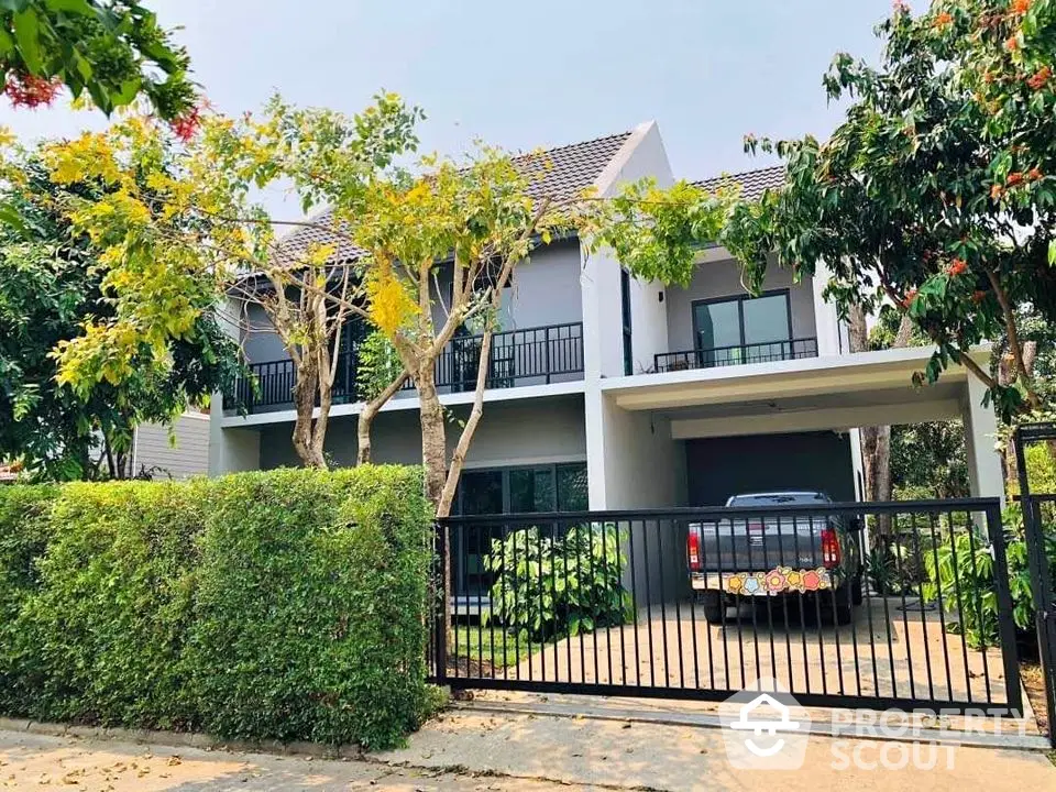 Modern two-story house with lush greenery and spacious driveway