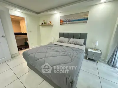 Cozy bedroom with modern decor and ensuite bathroom, perfect for relaxation and comfort.