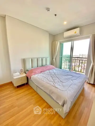 Bright bedroom with balcony view in modern apartment