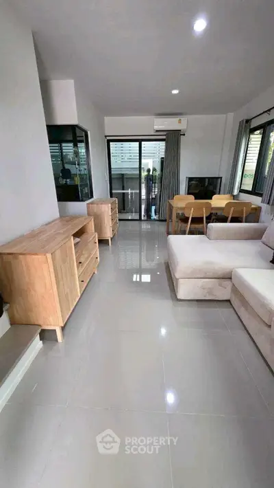 Modern living room with sleek furniture and large windows for natural light.