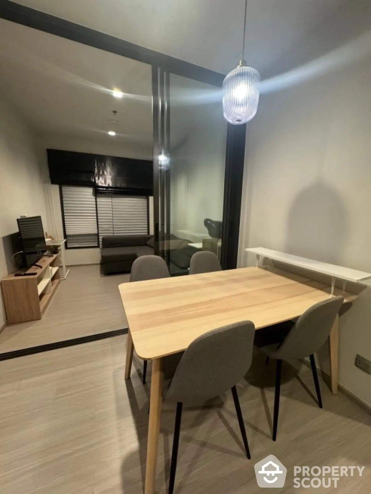 Modern dining area with sleek furniture and ambient lighting in a stylish apartment.