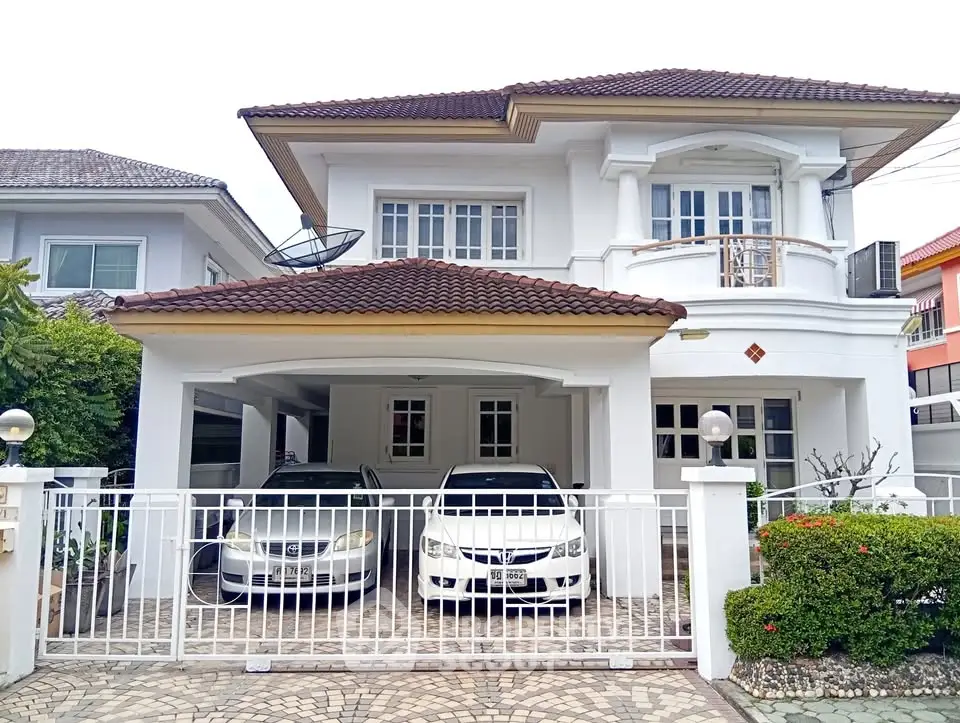 Elegant two-story house with spacious driveway and modern design in a serene neighborhood.