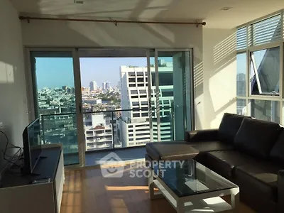 Modern living room with city view, featuring sleek furniture and large windows for natural light.