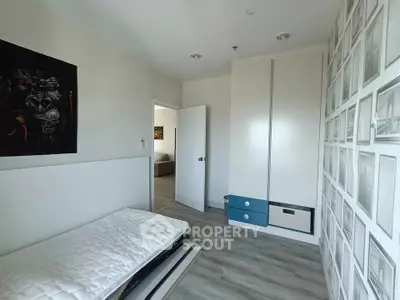 Modern minimalist bedroom with unique wall art and sleek storage solutions.