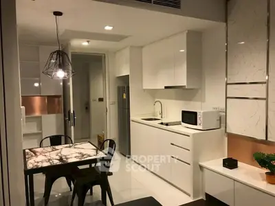 Modern kitchen with sleek white cabinets and marble dining table