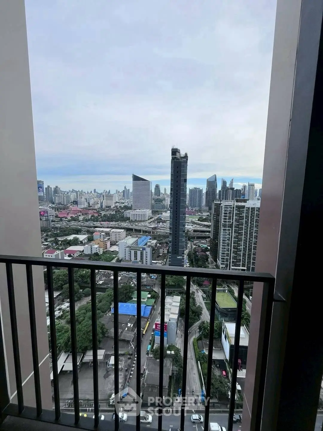 Stunning cityscape view from a high-rise balcony overlooking urban skyline.