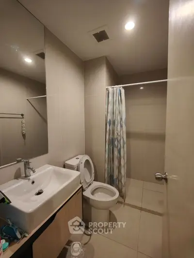 Modern bathroom with sleek fixtures and spacious shower area