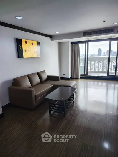 Spacious living room with city view and modern furnishings