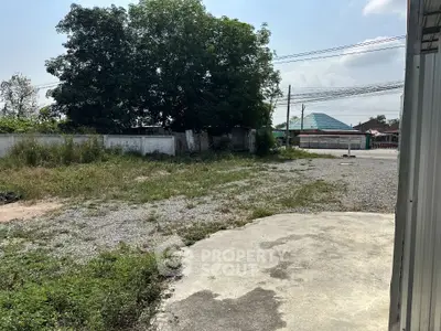 Spacious outdoor area with potential for development, featuring greenery and open space.