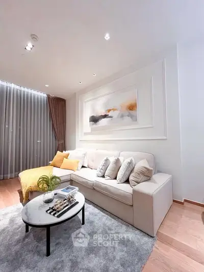 Stylish living room with cozy sofa, elegant decor, and soft lighting for a welcoming ambiance.