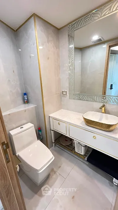 Luxurious bathroom with elegant marble tiles and modern fixtures in a stylish apartment.