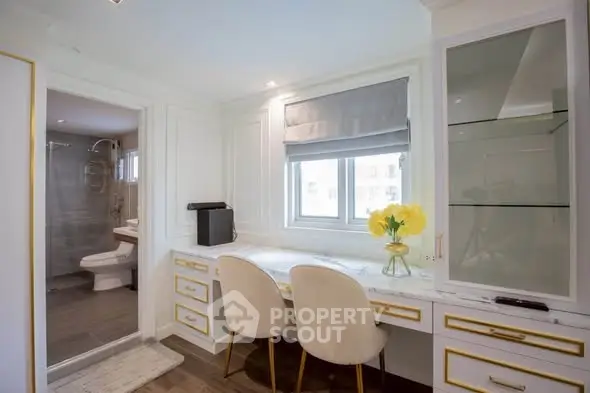 Elegant study area with dual chairs and bathroom view in modern apartment