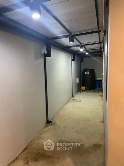 Modern hallway with industrial lighting and storage area
