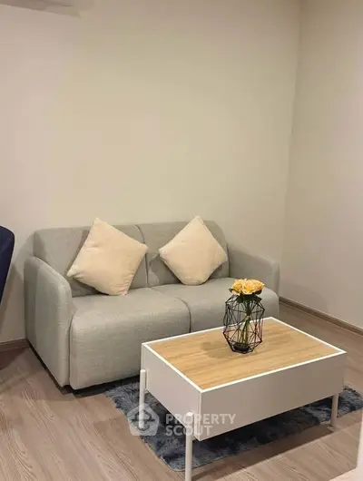 Cozy living room with modern gray sofa and stylish coffee table, perfect for relaxation.