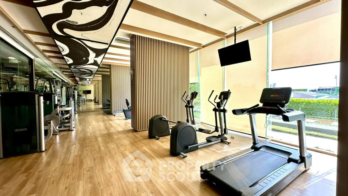 Modern gym with state-of-the-art equipment and large windows