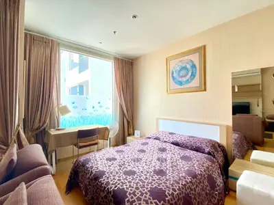 Cozy bedroom with stylish decor and ample natural light