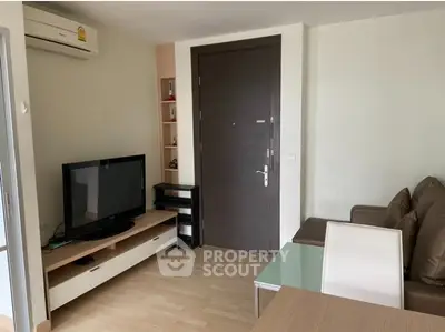 Modern living room with sleek furniture and entertainment center, perfect for relaxation and entertainment.