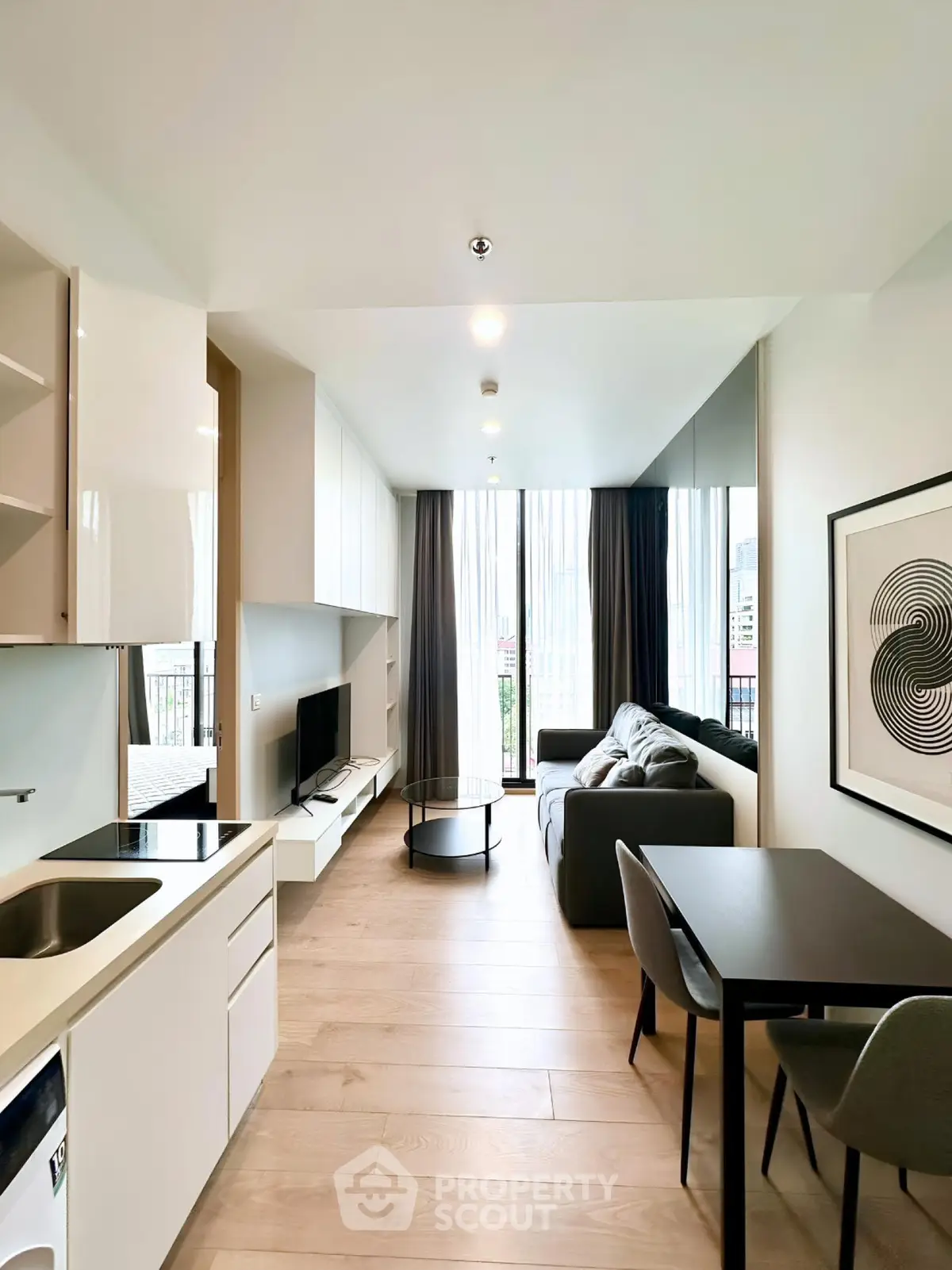 Modern living room with sleek design, open layout, and large windows offering city views.