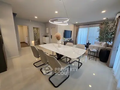 Modern open-plan living and dining area with elegant decor and natural light.
