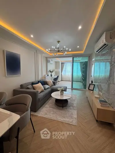 Modern living room with stylish decor, cozy seating, and ambient lighting in a contemporary apartment.