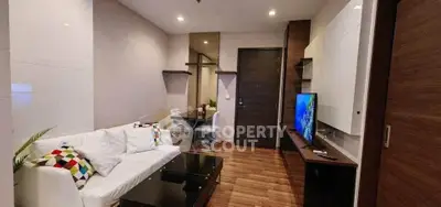 Modern living room with sleek furniture and vibrant decor accents.