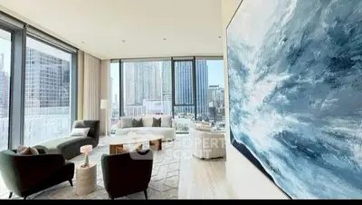 Luxurious living room with stunning city view and modern art decor.