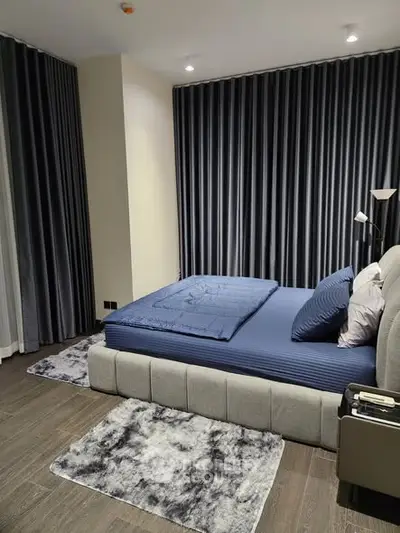 Luxurious modern bedroom with elegant decor and plush bedding in a stylish apartment.